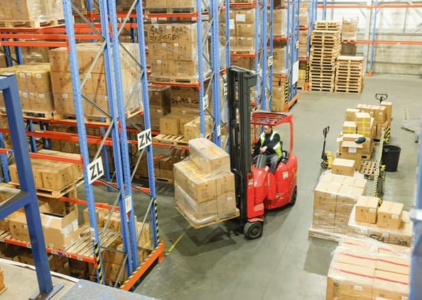 Forklift loading pallets in a Go Travel warehouse