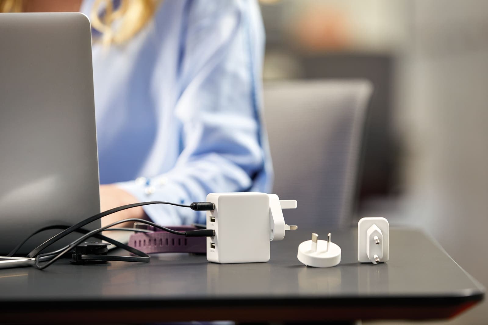 GO TRAVEL Worldwide USB-A Charger with multiple plug adapters on a desk.